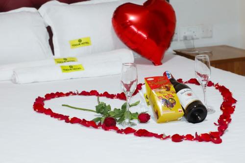 a valentines day table with a heart and wine glasses at Humming Cage Suites studios in Nairobi