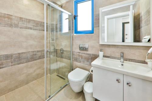 a bathroom with a shower and a toilet and a sink at Carpediem Apart in Kas