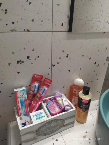 a container of toothbrushes and toothpaste on a counter in a bathroom at Pefkonas apartments2 100 m from the beach in Psakoudia
