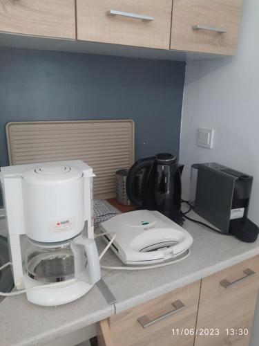 a kitchen counter with a white mixer and a printer at Pefkonas apartments2 100 m from the beach in Psakoudia
