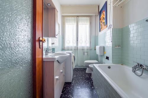 een badkamer met een bad, een wastafel en een toilet bij Blumele Lovely Sea View Apartment in Deiva Marina