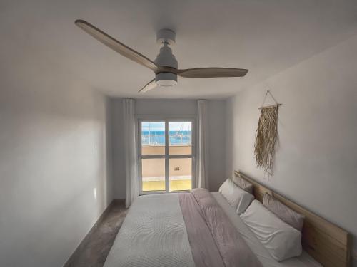 a bedroom with a ceiling fan and a bed at Kailua Dream in Almerimar