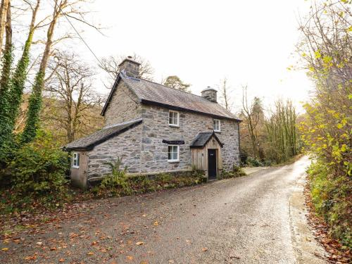 an old stone house on the side of a road at Pen y Bont in Machynlleth