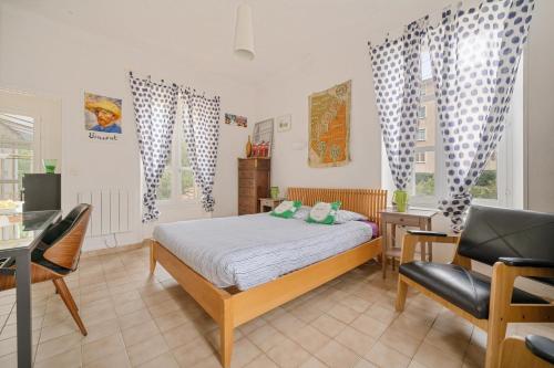 a bedroom with a bed and a desk and a chair at Alexandra Apartments in Digne-les-Bains