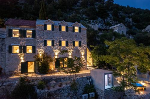 an aerial view of a stone house with lights at Murvica resport in Murvica