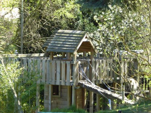 a wooden bird house in the middle of a yard at Landhotel Rebstock in Oberkirch