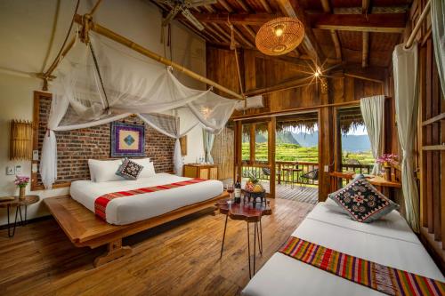 a bedroom with two beds and a window at Puluong Valley Home in Thanh Hóa
