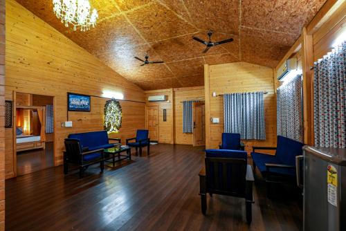 a waiting room with blue chairs and a table at Brahmi Resort in Bangalore