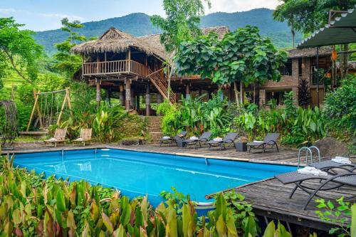 a resort with a swimming pool and a house at Puluong Valley Home in Thanh Hóa