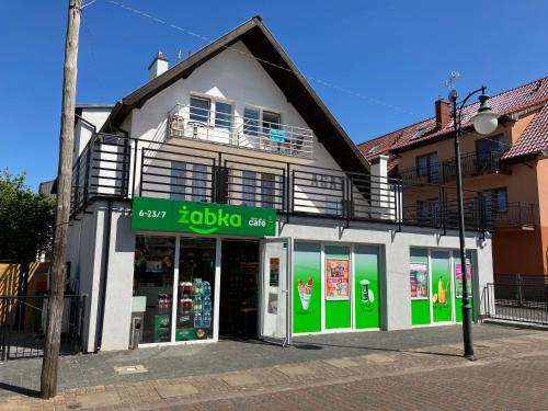 a store on the side of a street at AGAT Pokoje Gościnne Apartamenty in Pobierowo