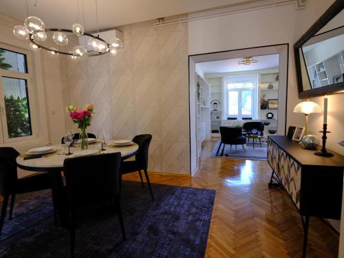 a dining room with a table and chairs at Bristol Apartment in the Centre of Zagreb in Zagreb