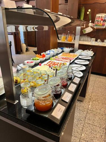 a buffet line with many different types of food at Boutique-garni Hotel Papillon in Kempen