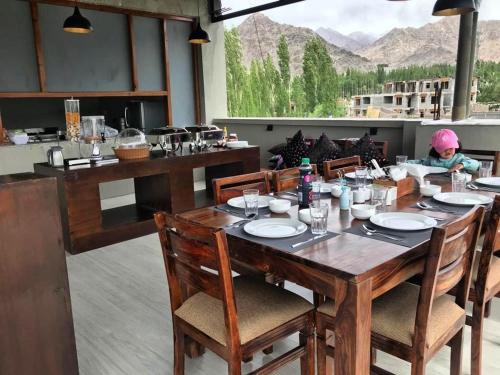 a dining room with a table and a view at Maple house ladakh in Leh