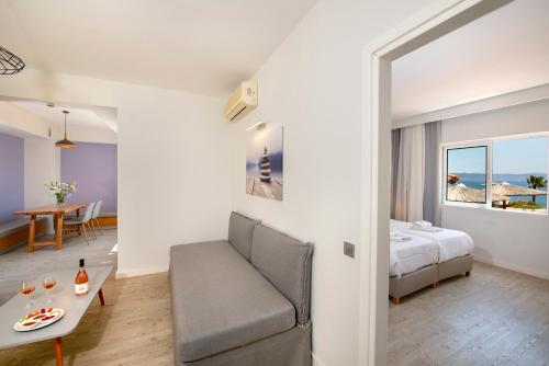 a bedroom with a bed and a couch and a table at Balos Beach in Kissamos