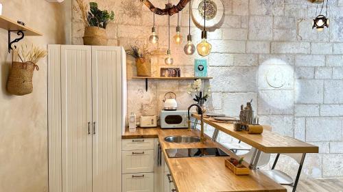 a kitchen with a counter and a sink in it at Boutique apartment in heart of Haifa in Haifa