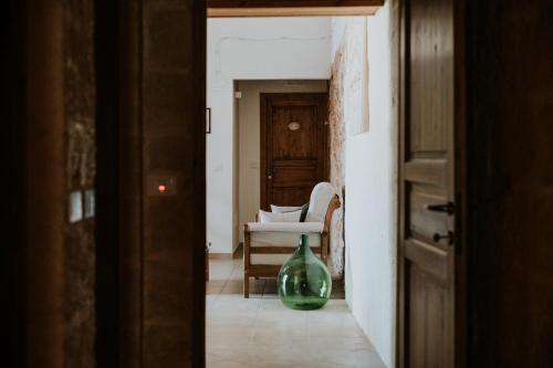 a hallway with a green glass vase in a room at Il Giardino del Priore Dimora Rurale in Ugento