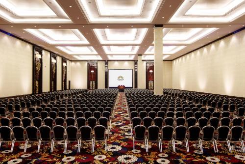 an empty room with chairs and a screen at The Trans Luxury Hotel Bandung in Bandung