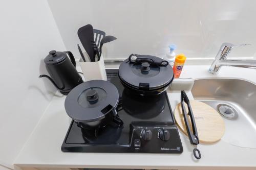 a coffee maker sitting on a counter next to a sink at Setagaya House by Tranova in Tokyo