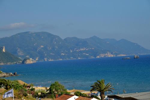 a view of a large body of water with mountains at Costal apartment in Glyfada