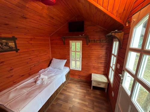 a bedroom with a bed in a wooden house at Sweet horses HH1 in Didim