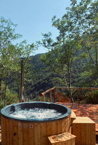 a wooden hot tub sitting on top of a deck at SKY HOUSE Experience in Orco Feglino