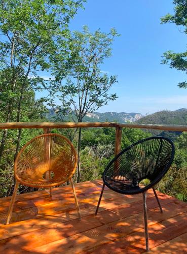 two chairs sitting on top of a wooden deck at SKY HOUSE Experience in Orco Feglino