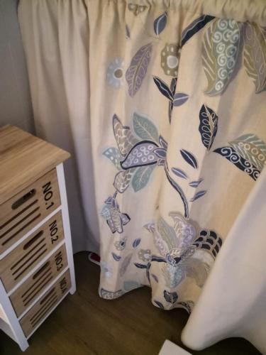 a bed with a curtain with butterflies on it at il Borgo in Capolona
