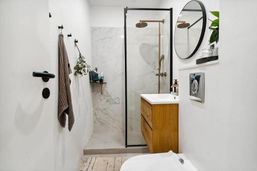 a bathroom with a shower and a sink at Great central apartment walking distance to metro in Copenhagen