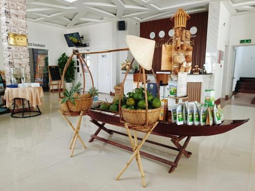 a display in a store with baskets of fruits and vegetables at Khách sạn Hậu Giang in Vị Thanh