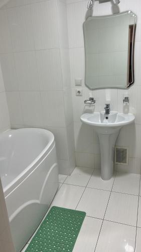 a bathroom with a sink and a toilet and a mirror at Kapriz Issyk Kul Resort in Cholpon-Ata