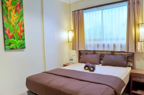 Un dormitorio con una cama con dos animales de peluche encima. en The Hill Ungasan, en Uluwatu