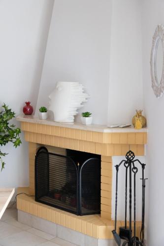 a brick fireplace with dishes on top of it at Electra in Saronida