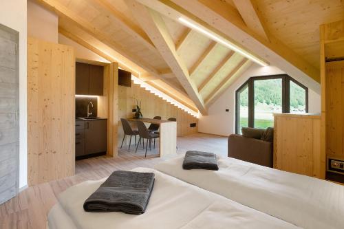 a room with two beds and a kitchen in a house at Agriturismo Bosco d'oro 5 in Livigno