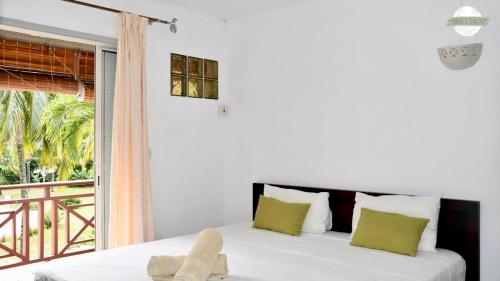 Ένα ή περισσότερα κρεβάτια σε δωμάτιο στο Perfect Escape - Kenville Residence near Bain Boeuf Beach