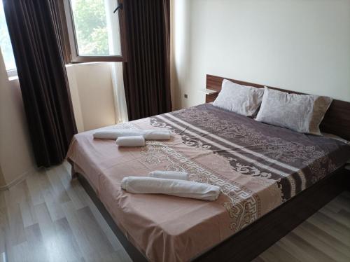 a bedroom with a bed with two towels on it at One Bedroom Apartment 10 - Vasil Aprilov 64 Plovdiv in Plovdiv