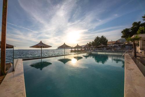 a swimming pool with a view of the ocean at Hotel Jaroal in Sarandë