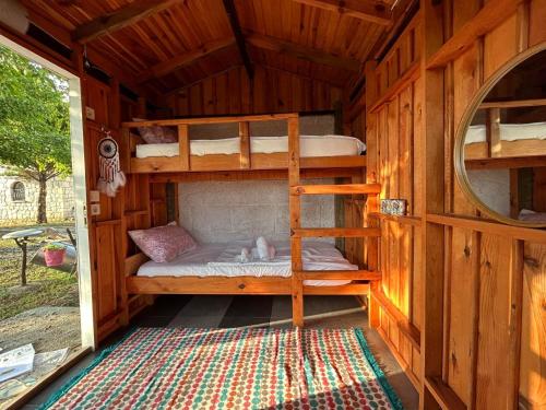 a bedroom with bunk beds in a wooden cabin at sweet horses HH4 in Didim