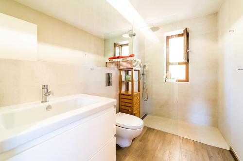 a bathroom with a sink and a toilet at Salthouse Portugal - Stylish Duplex Apartment in Aljezur