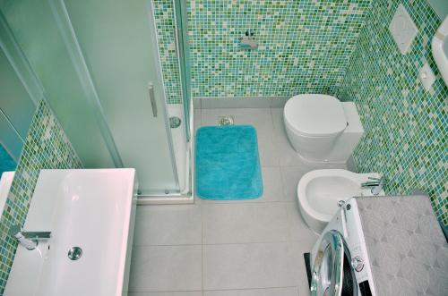 a bathroom with a toilet and a sink and a shower at Residence Agorà in Bibione