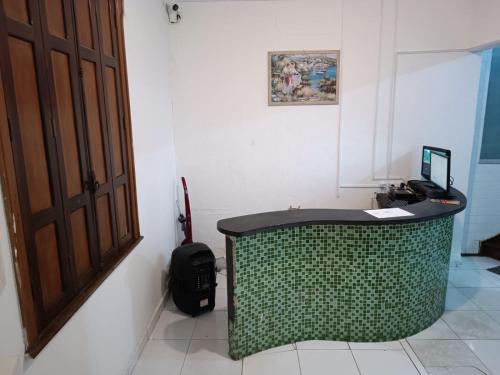 a room with a desk with a computer on it at Mansão Akkui Hostel in Sao Paulo