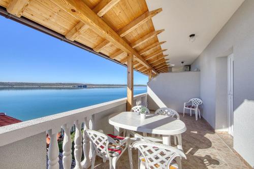 einen Balkon mit einem Tisch und Stühlen sowie Blick auf das Wasser in der Unterkunft Gazic, no 3 in Zadar