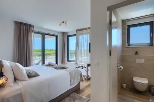 a bedroom with a large bed and a window at Villa Chiara by SeeAdria Agency in Brtonigla