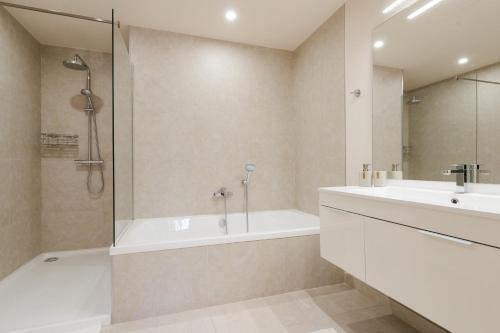 a bathroom with a tub and a sink and a shower at Jardinana - apartment with two bedrooms close to beach and town center in La Cala de Mijas