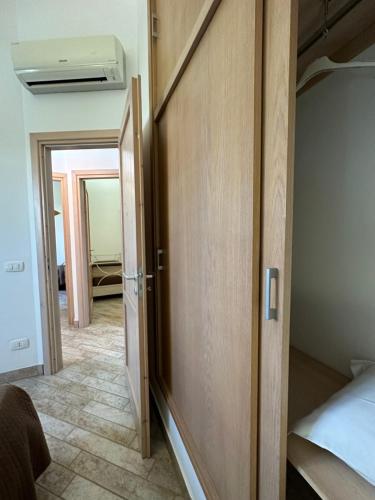 a hallway with a door leading to a bedroom at Baglio Mazzara in Custonaci