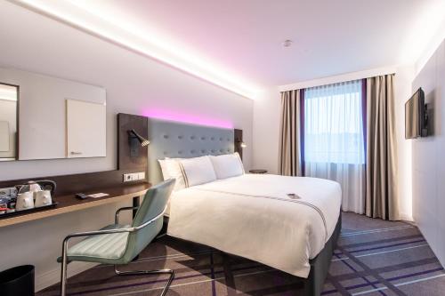 um quarto de hotel com uma cama grande e uma secretária em Premier Inn Nürnberg City Nordost em Nurembergue