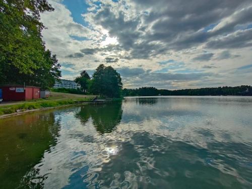 a large body of water with a cloudy sky at Apartament nad jeziorem Białym Augustów in Augustów