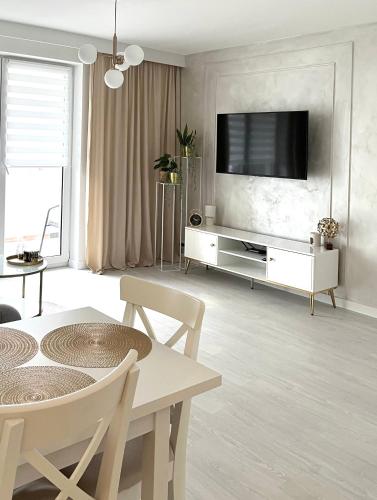 a living room with a television on a wall at Apartament in Bochnia