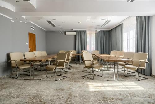 a conference room with wooden tables and chairs at Hotel Antoni in Tomaszów Lubelski