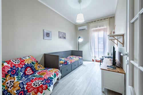 a bedroom with a bed and a desk in it at Bacicagiuba Apartments in Termini Imerese