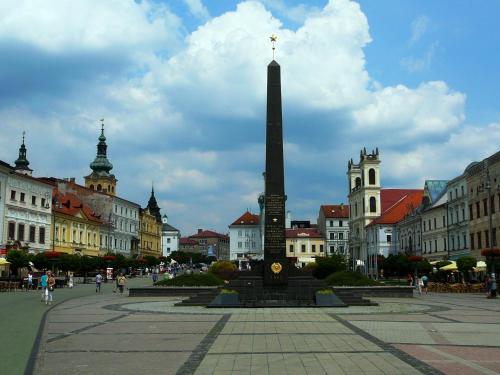 a square with a monument in the middle of a city at Urpí­n City Residence in Banská Bystrica